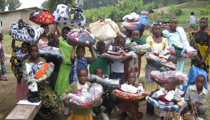 Isange primary students receiving items for school
