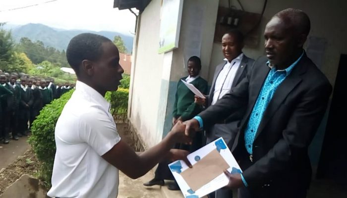 Isange secondary student receiving Award